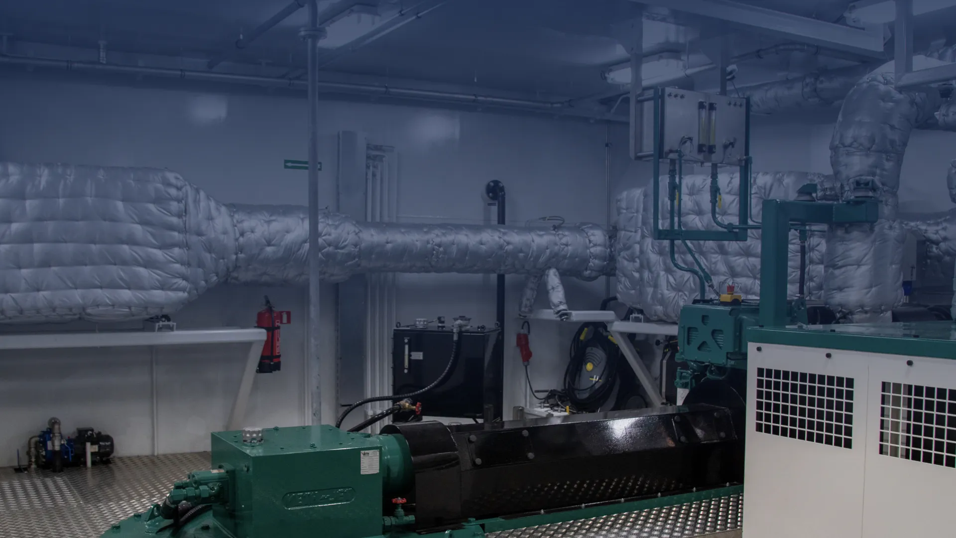 This image shows a Diesel Particulate Filter (DPF) combined with an SCR catalyst in a ship's engine room.