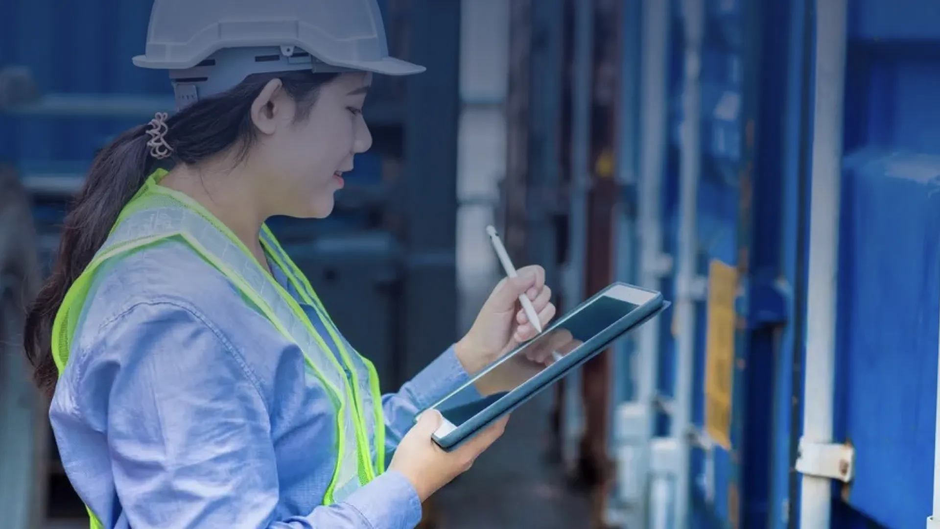 A female crew member uses a tablet to operate the Chemical Management System aboard a ship.